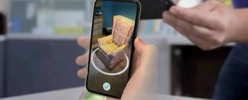A scanned chair previewed in augmented reality on a phone